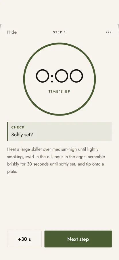 Garnished cooking mode on step 1, a timer reading 0:00, time's up, with a Next step button